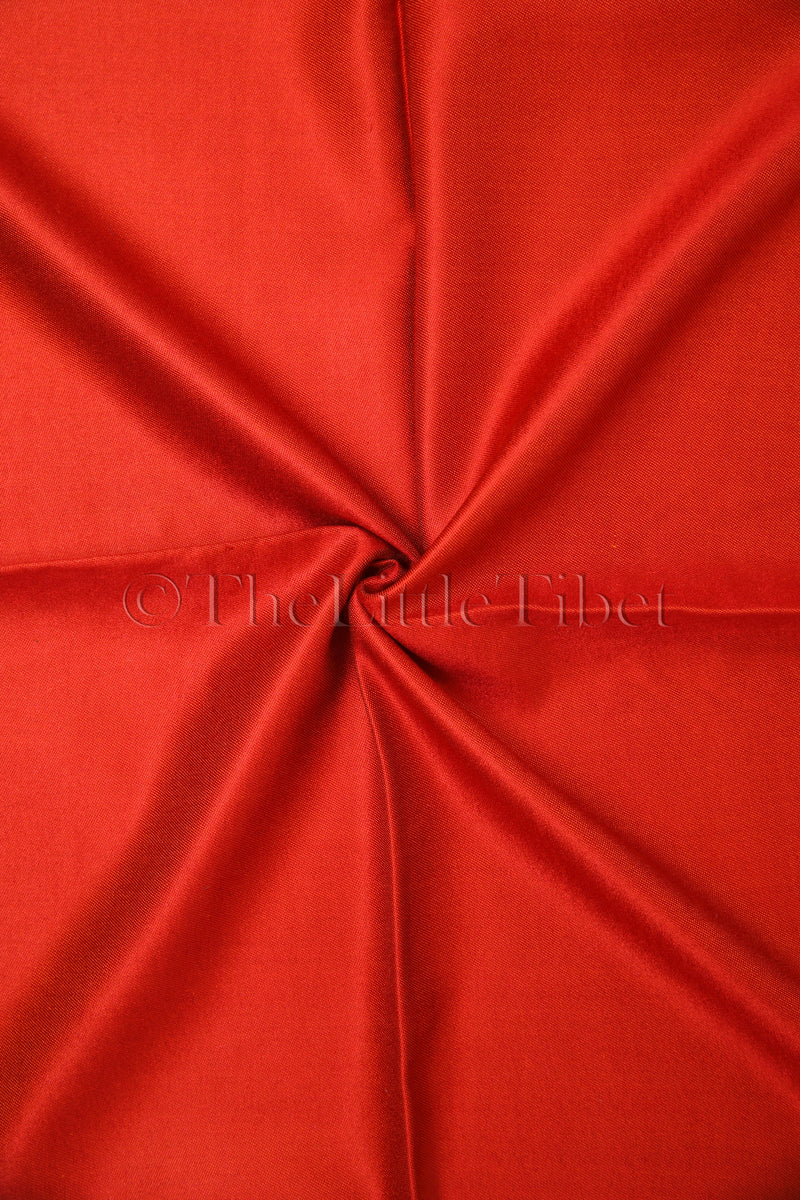 close up shot of the red side of the reversible silk scarf
