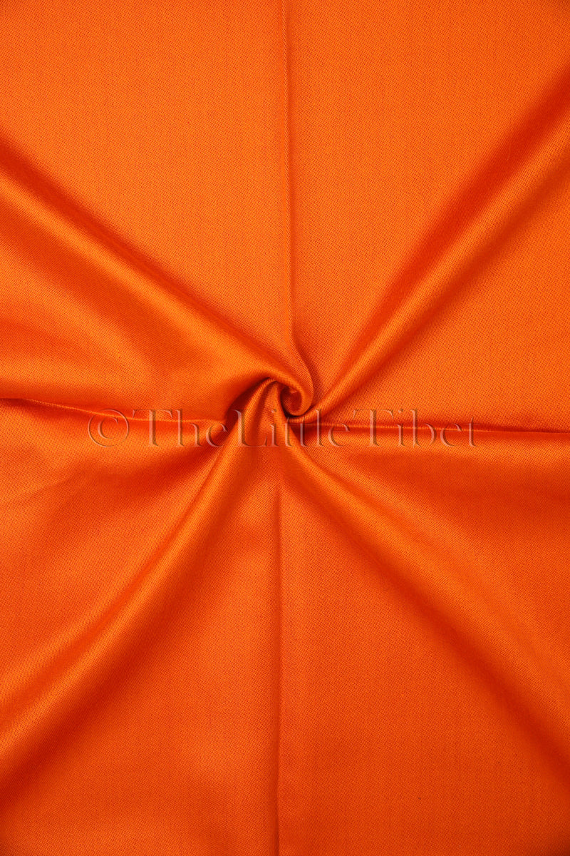 close up shot of the orange side of the reversible two-tones silk scarf made in tibet
