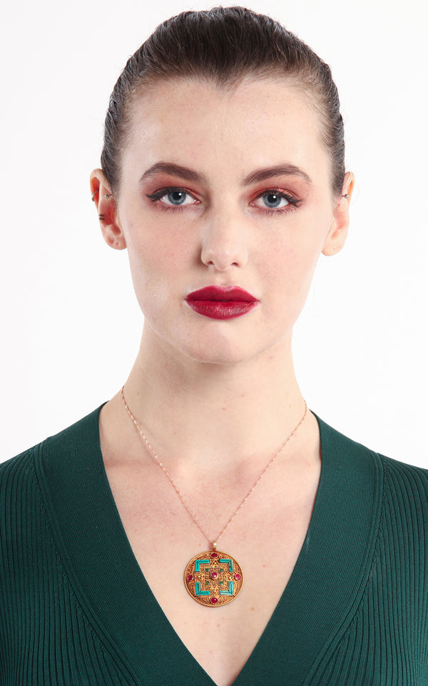 model wearing Geometric Gold Plated Tibetan Mandala Pendant turquoise ruby emerald accents 