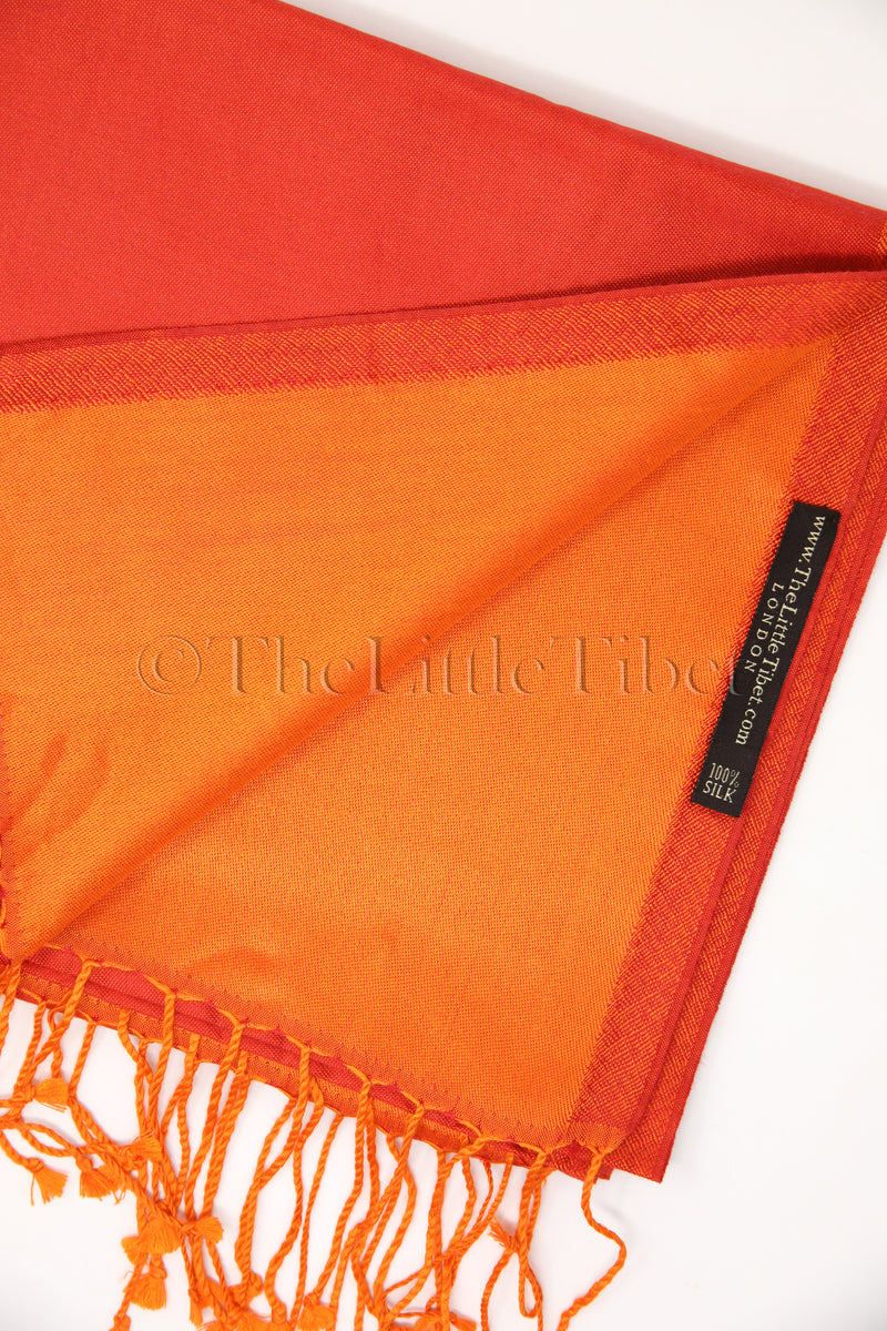 close up shot of reversible red orange silk scarf