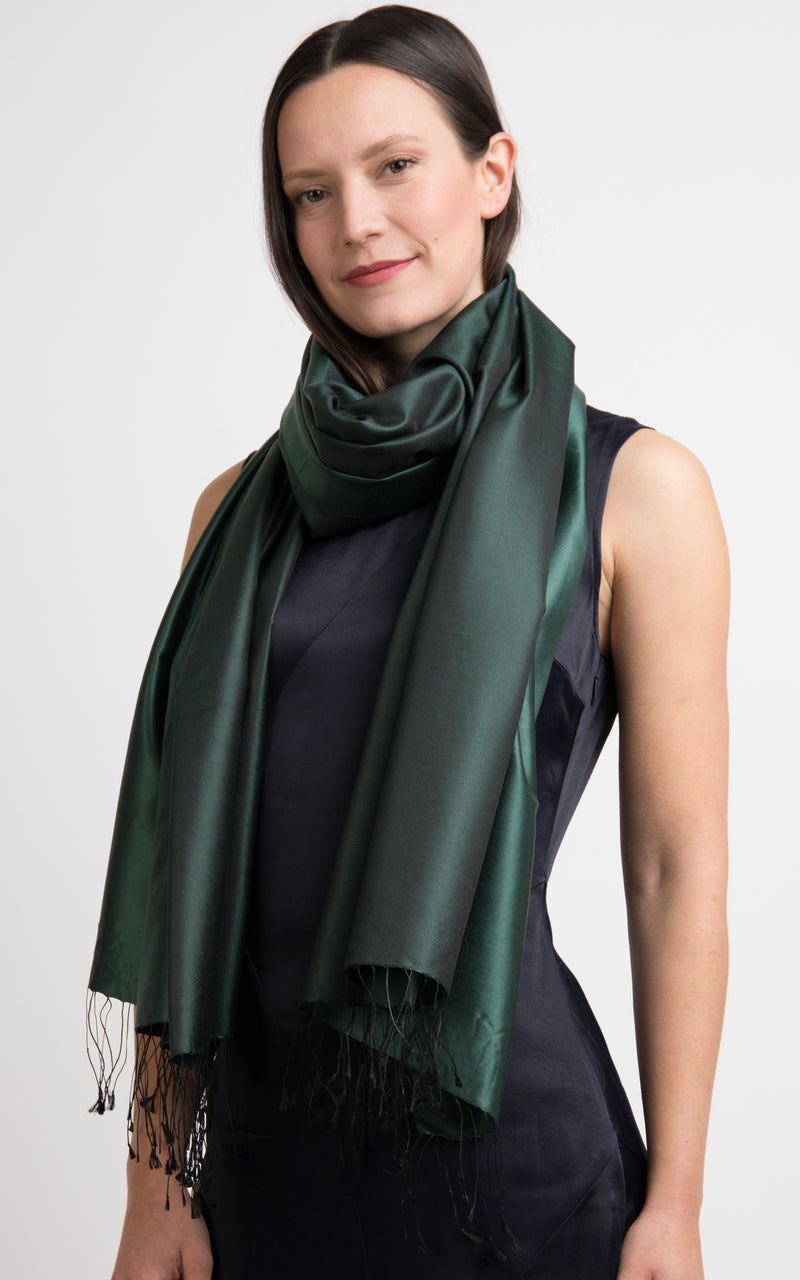  model wearing a reversible silk wrap pashmina shawl in plain forest green and dark green, made out of pur model wearing a reversible silk wrap pashmina shawl in plain forest green and dark green, made out of pure silk from The Little Tibete silk from The Little Tibet