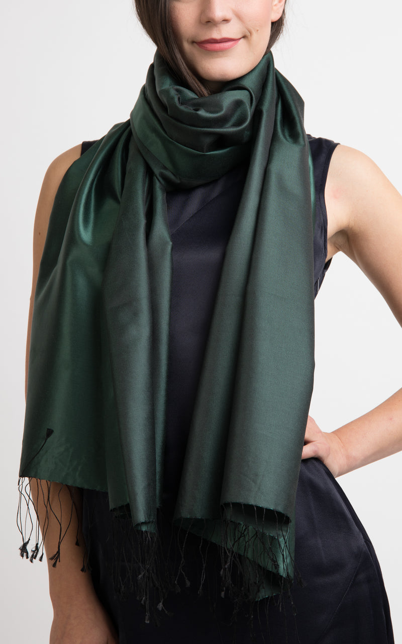model wearing a reversible silk wrap pashmina shawl in plain forest green and dark green, made out of pure silk from The Little Tibet