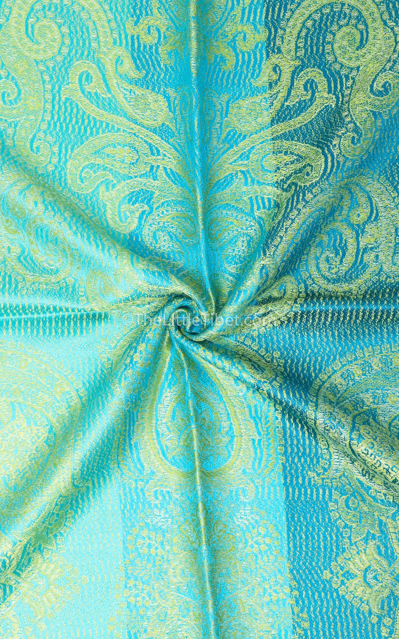 Close up of Vibrant green pure silk pashmina with bright blue accents and paisley detail