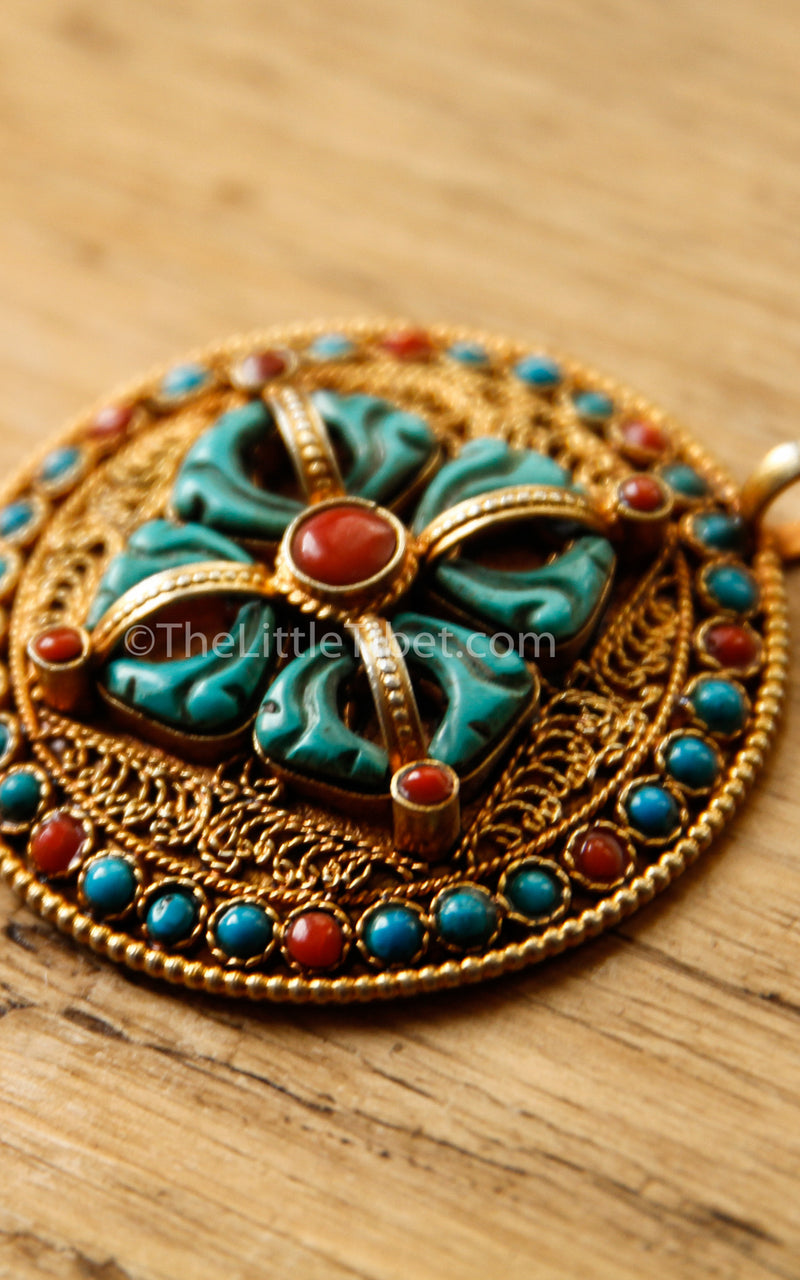 Circular Gold Double Dorjee Pendant turquoise coral accents side view