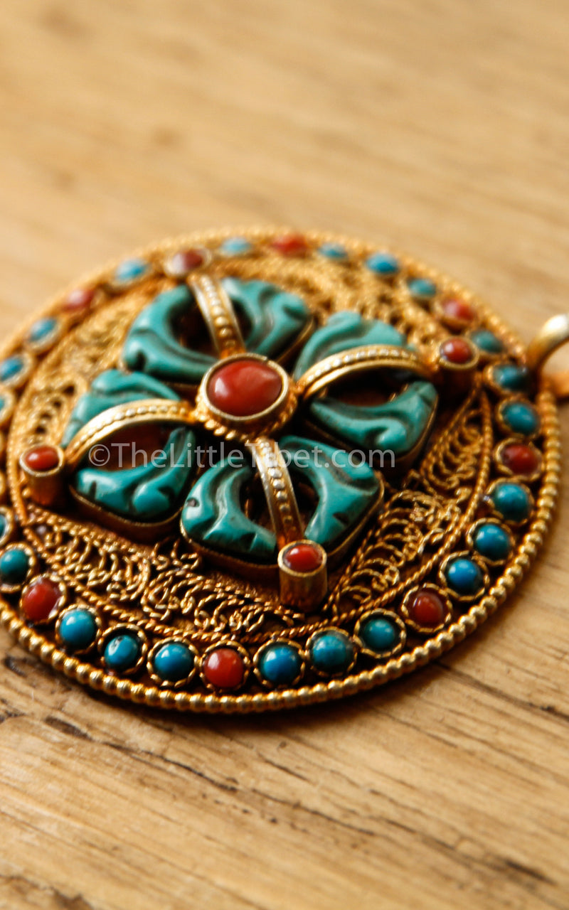 Circular Gold Double Dorjee Pendant turquoise coral accents side view