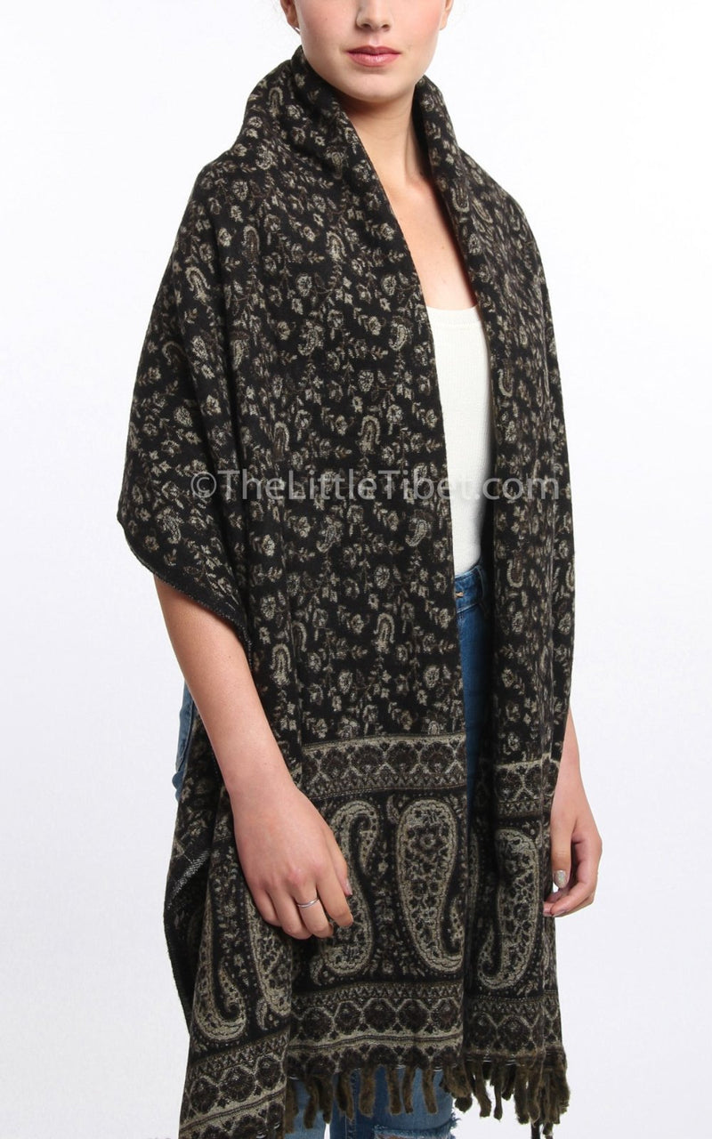 Dark seaweed green cream paisley design reversible tibet shawl  with tassels draped around shoulders