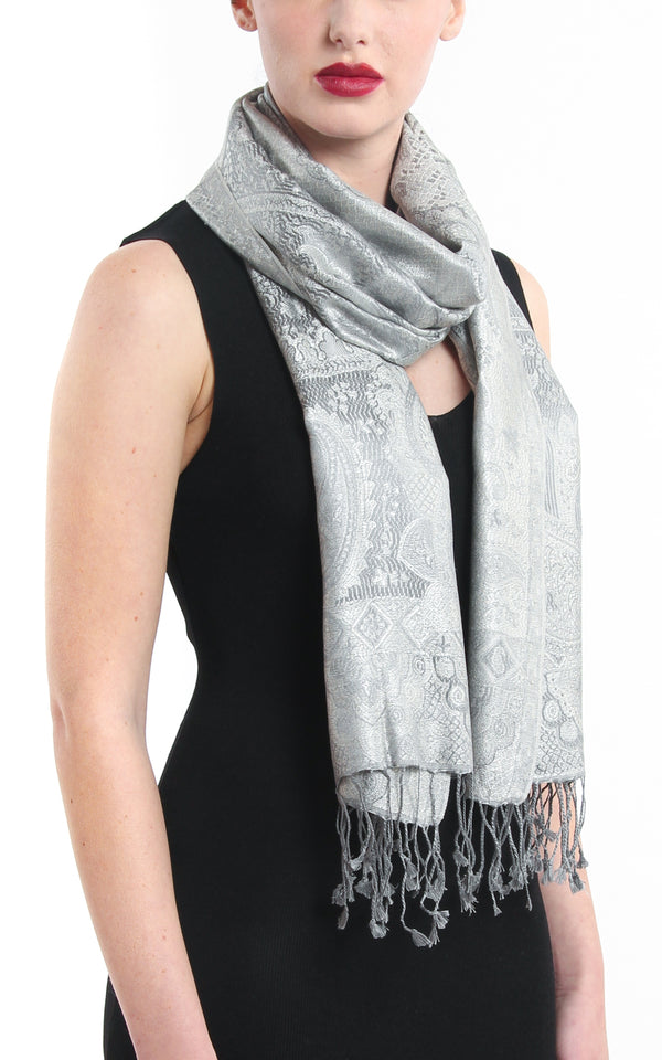 Beautiful light catching silver pure silk scarf pashmina with elegant tassels styled around the neck