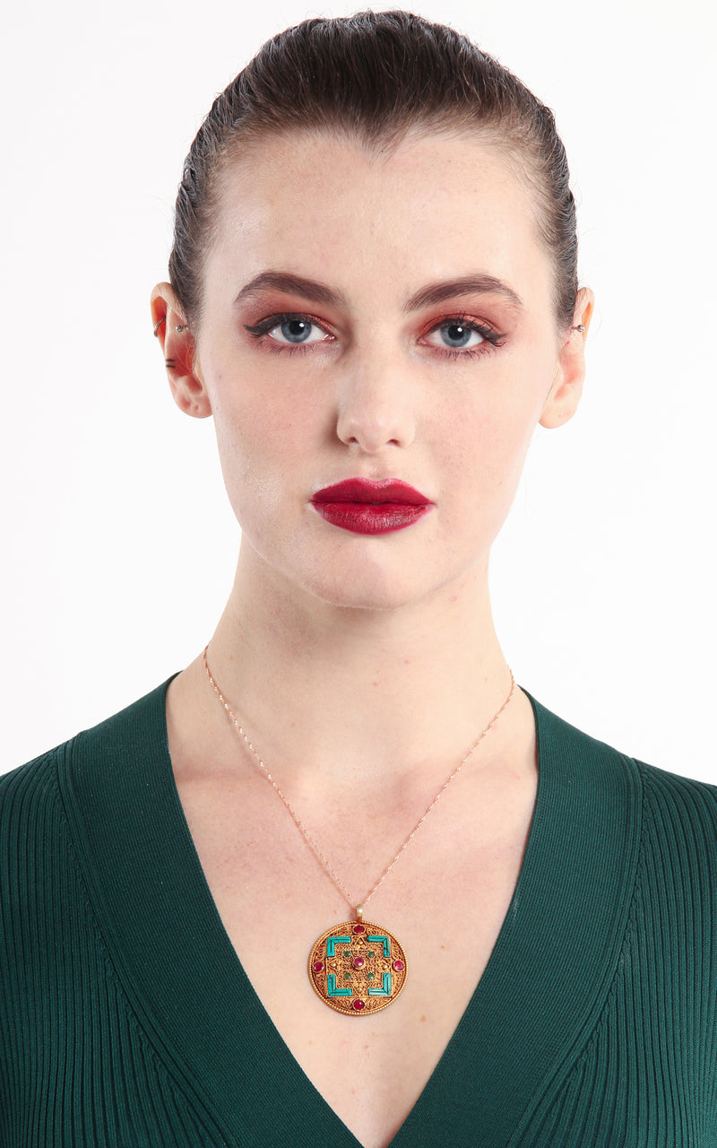 model wearing Geometric Gold Plated Tibetan Mandala Pendant turquoise ruby emerald accents 