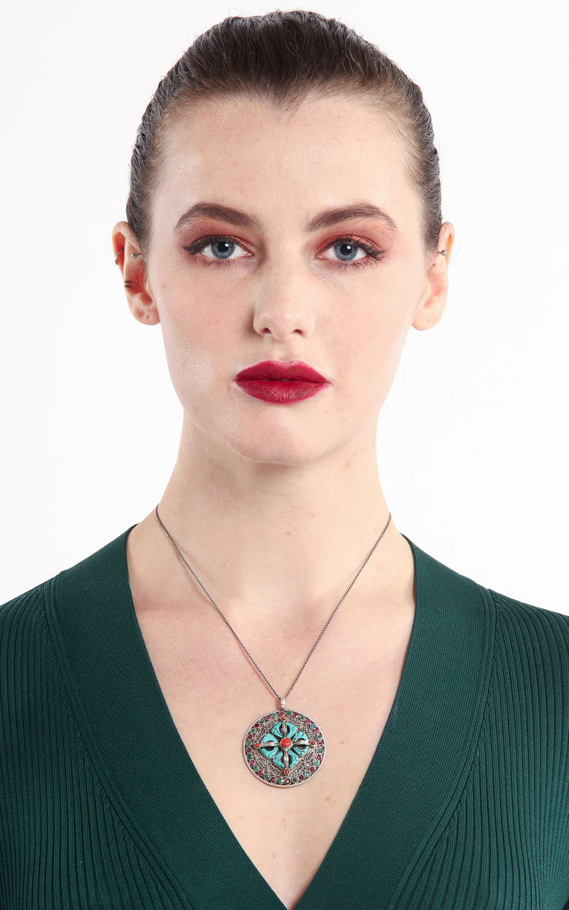 model wearing Silver ruby emerald accents double Thunderbolt Double Dorjee Pendant