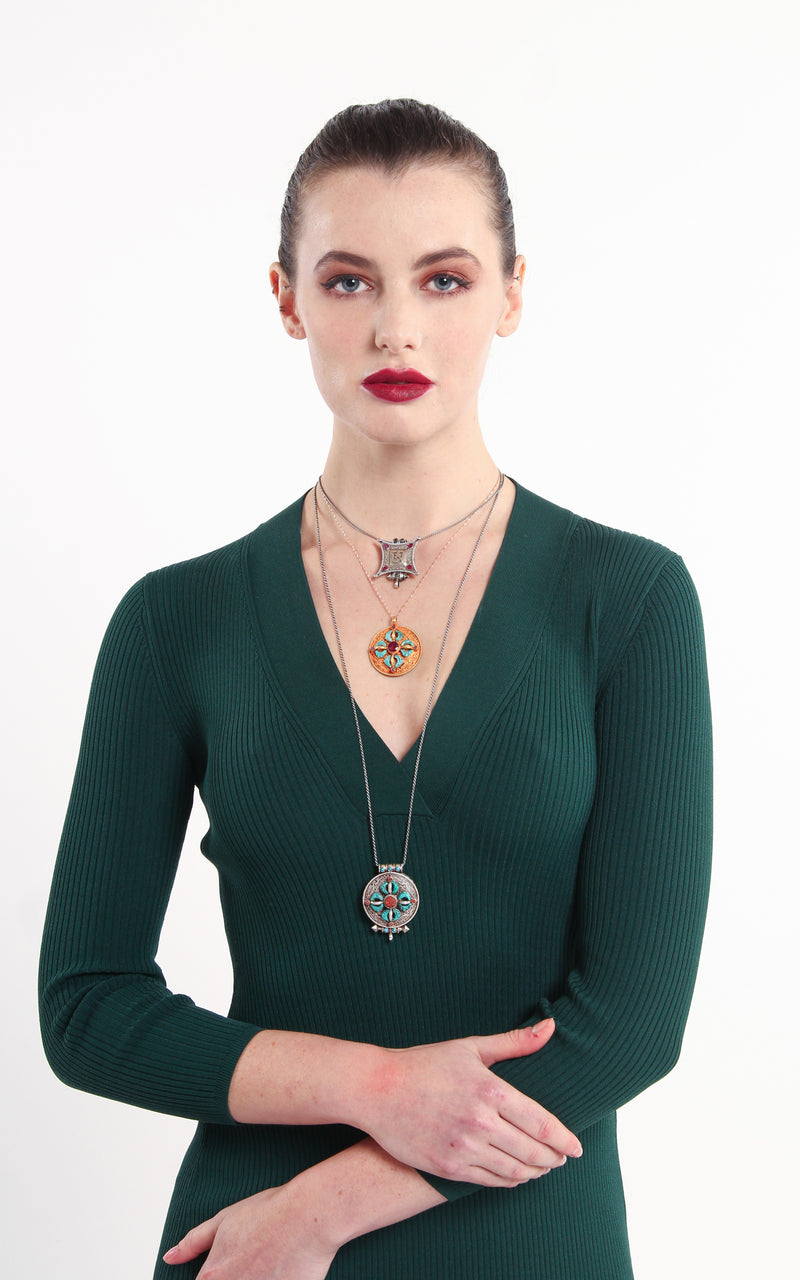 model wearing circular Gold Plated Double Dorjee Locket ruby emerald 