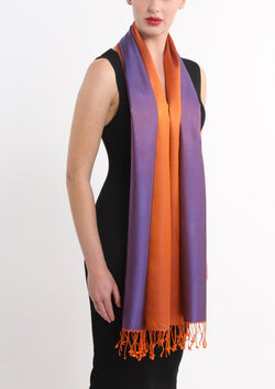model wearing reversible orange purple silk scarf worn on the shoulder 100% pure silk